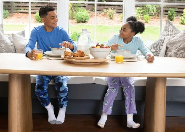 Kids eating breakfast in pajamas.