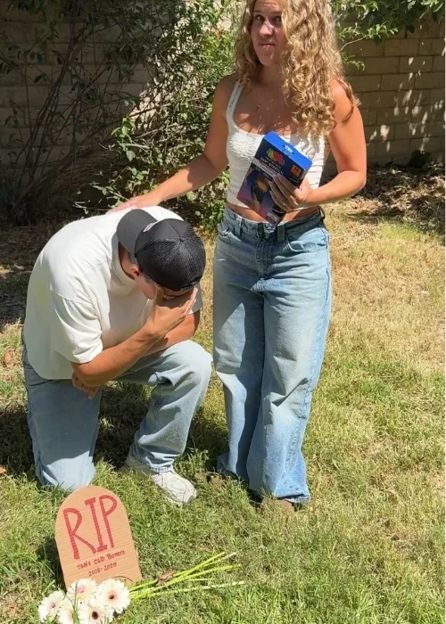 A Rest in Peace fake tombstone with a man looking down at it sad. A women is standing next to him being sympatric holding a box of new underwear to remind him its time to buy some new ones and get rid of his old.