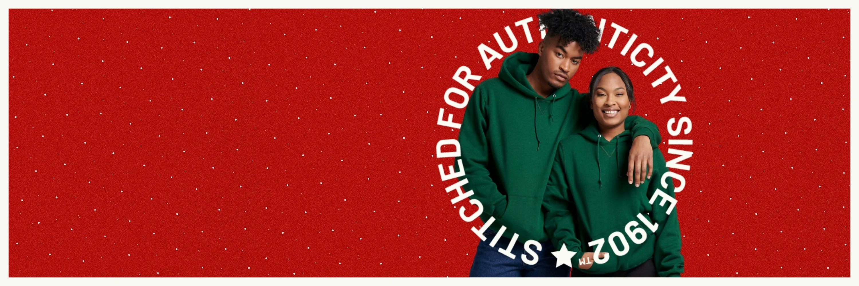 man and woman wearing a Christmas green Russell Athletic hoodie with text overlay stitched for authenticity since 1902