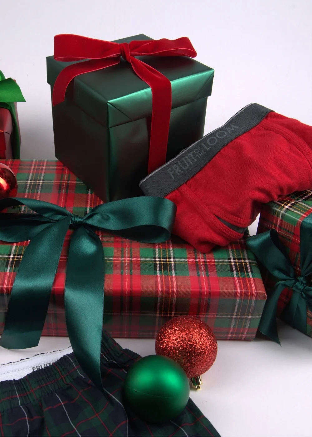 fruit of the loom men's boxers and boxer briefs placed on wrapped Christmas presents for the holidays.