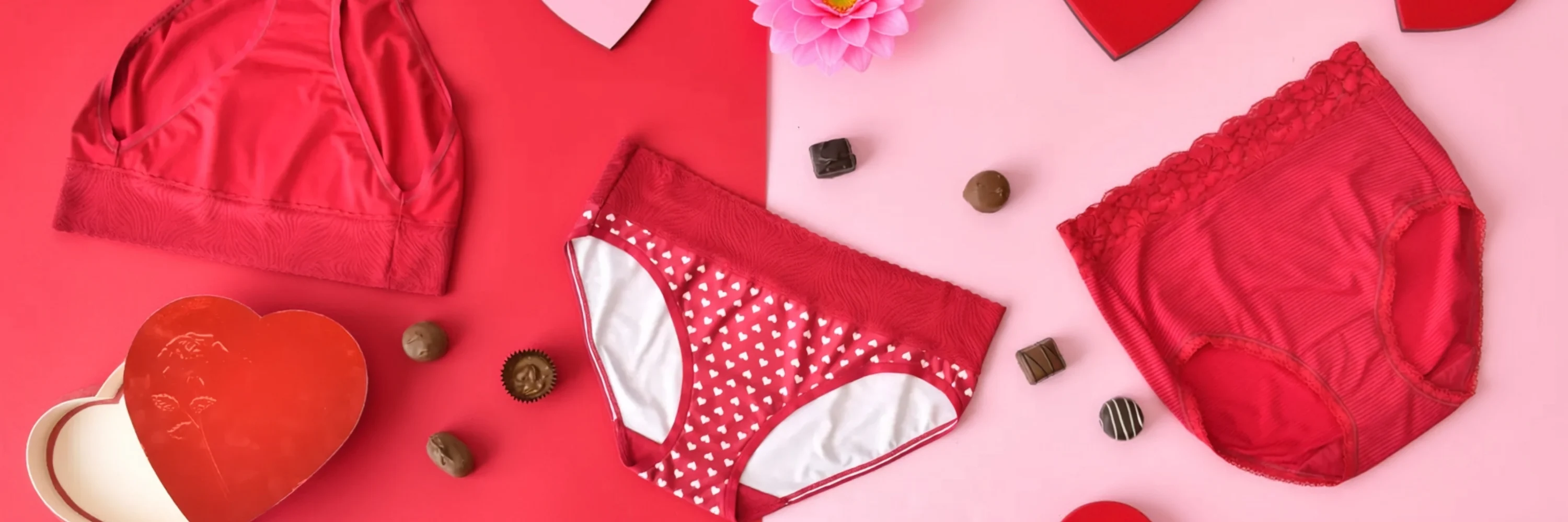 Model wearing a Vanity Fair Lingerie black bra and matching panty set, reclining on a cream-colored couch, showcasing elegant and comfortable lingerie style.