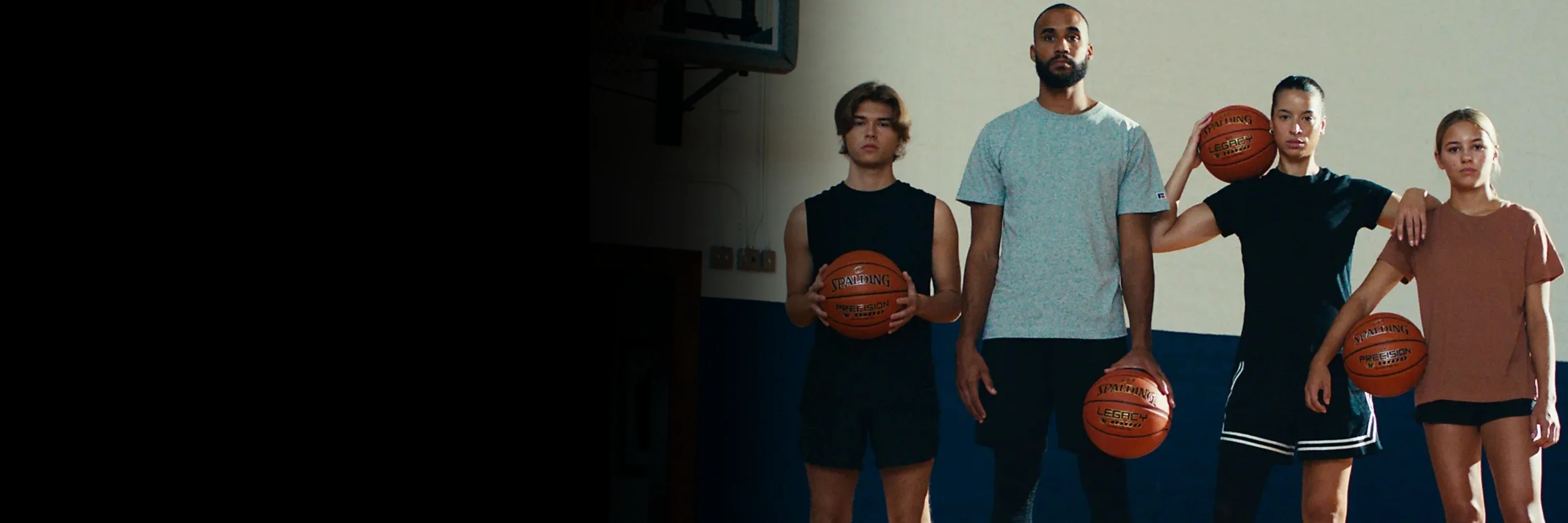 Basketball players with Spalding TF‑1000 Legacy and Precision balls on indoor court