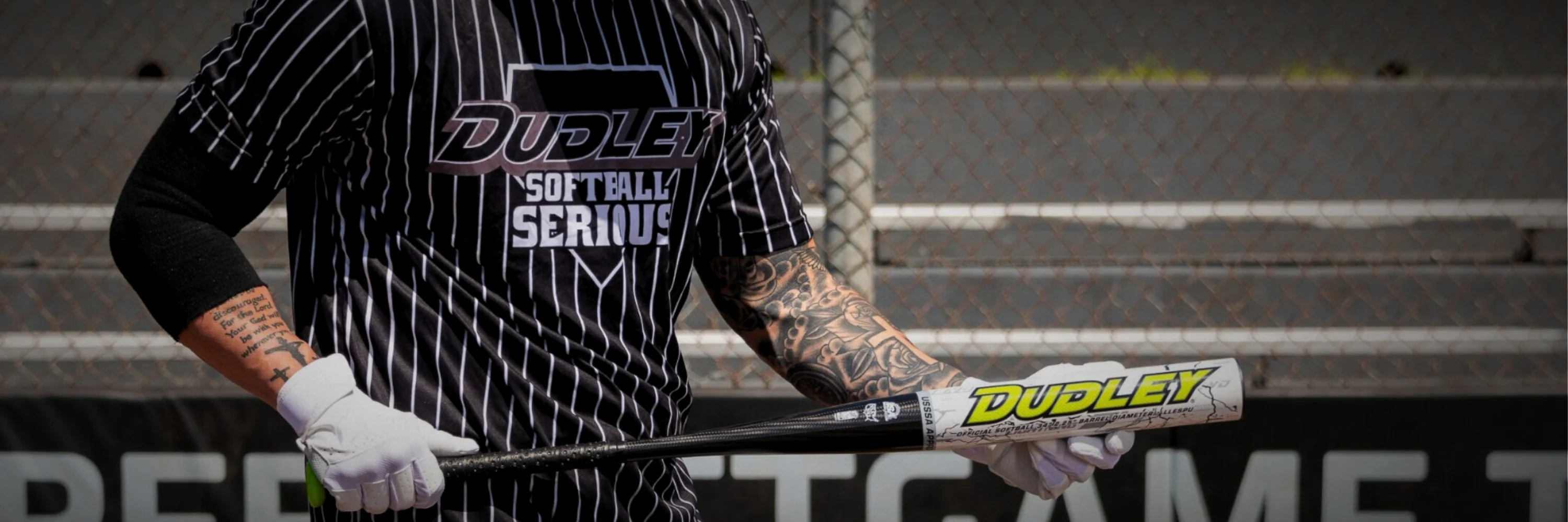 Male softball player holding a dudley lightning slow pitch bat