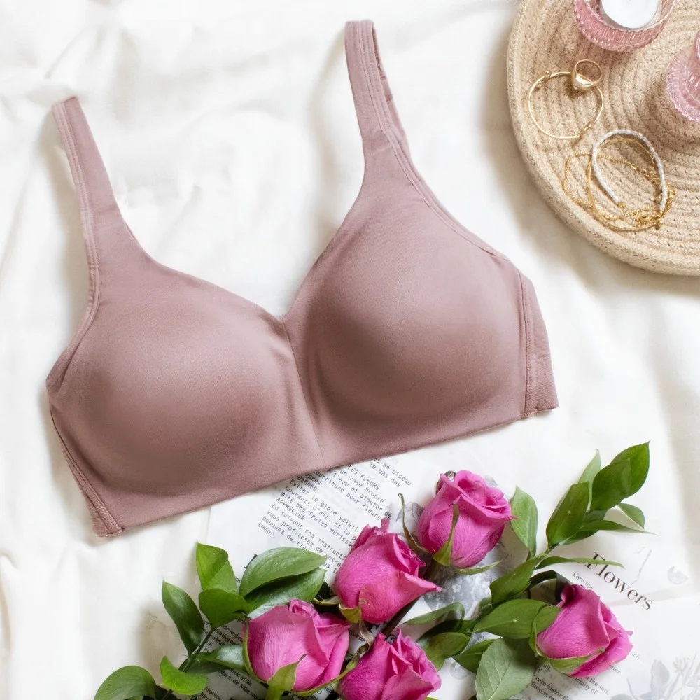 Close-up of a wireless bra cup and band showing soft, lightly lined fabric being gently stretched.