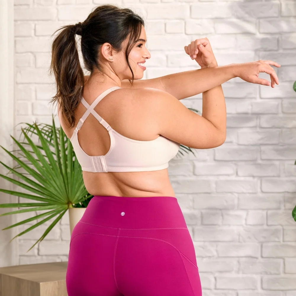 Back view of medium‑impact wireless sport bra showing crisscross convertible straps.