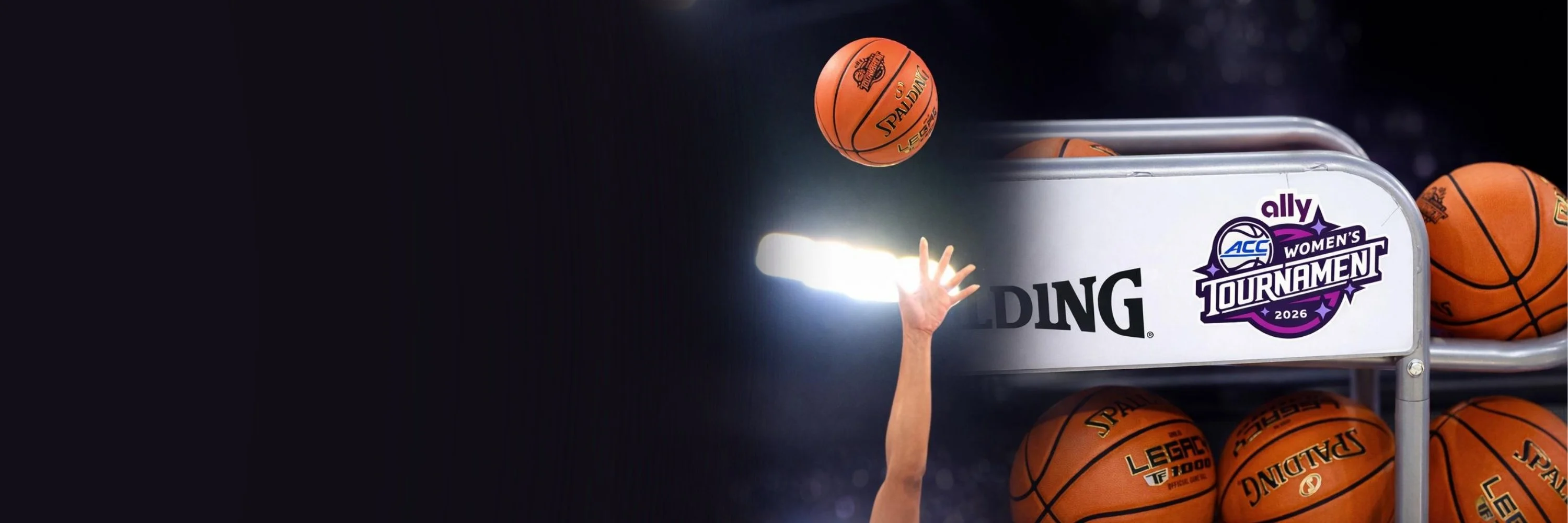 Spalding Legacy 1000 basketballs on a sideline rack during the ACC Women’s Tournament, featuring custom tournament engraving and the Ally ACC Women’s Tournament logo.