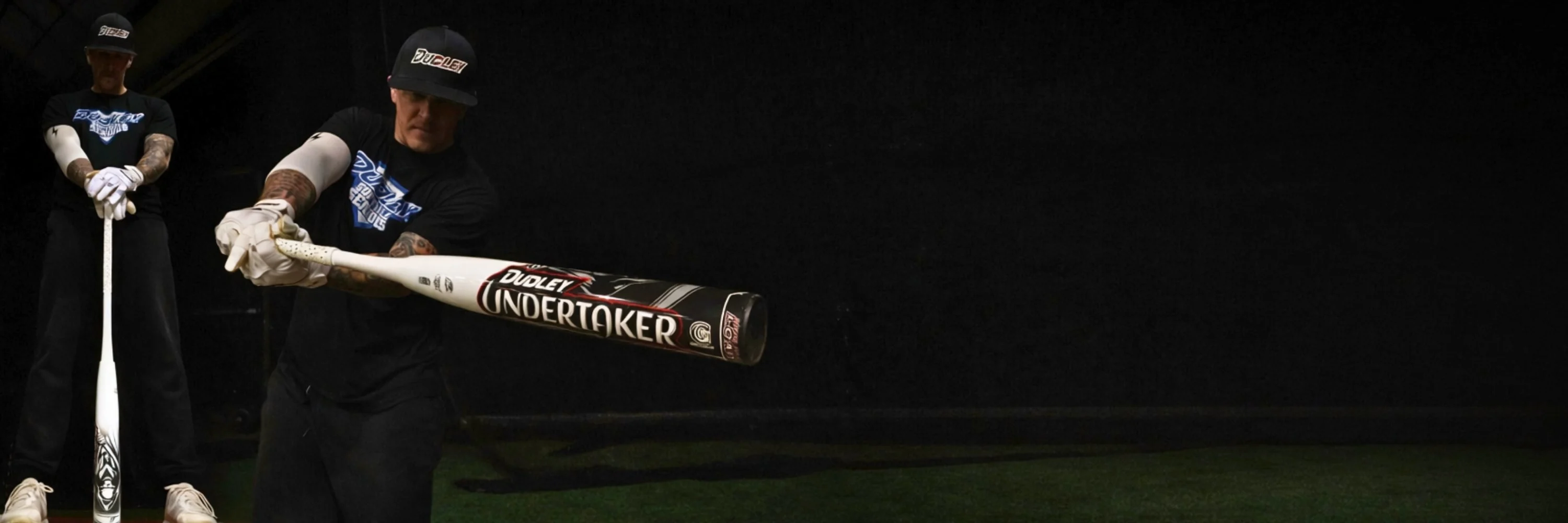 Male softball player holding a dudley undertaker slow pitch bat
