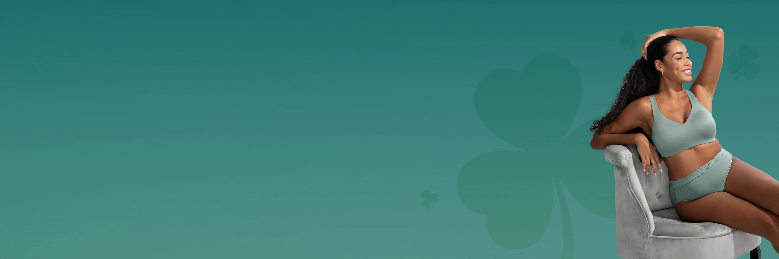 Model wearing a Vanity Fair Lingerie milky jade and matching panty set, reclining on a cream-colored couch, showcasing elegant and comfortable lingerie style.