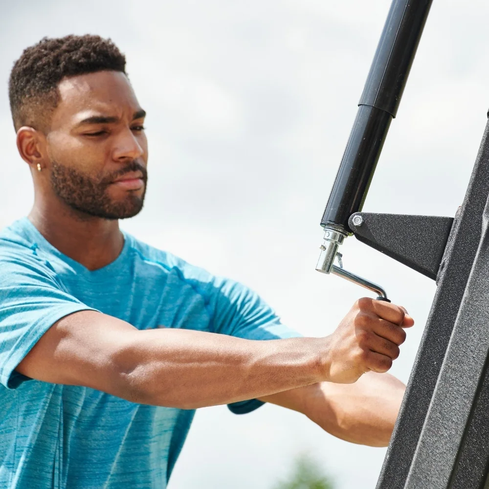 man easily adjusting the height of the beast portable system