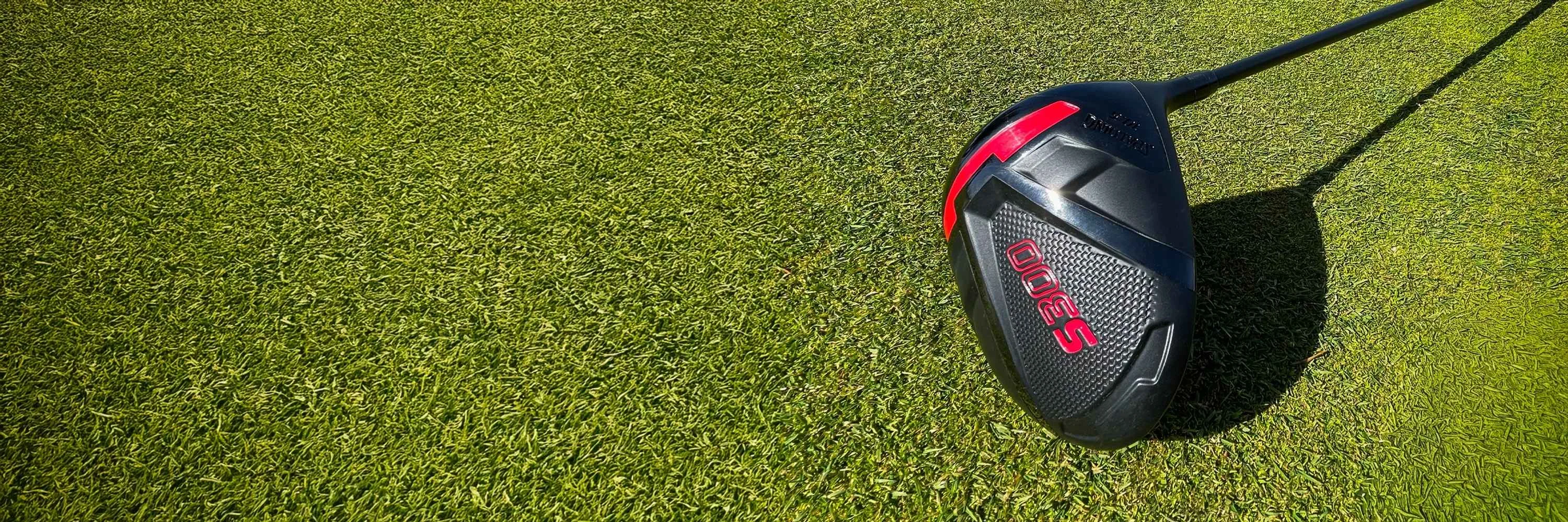 Close-up of a Spalding S300 golf club head resting on a grassy fairway.