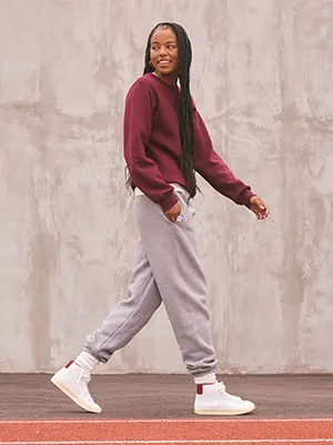 Model wearing red russell athletic sweatshirt and grey sweatpants