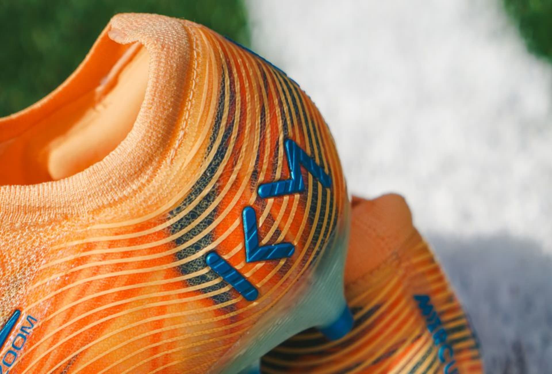 A pair of purple Nike Gear Up football boots on the grass.