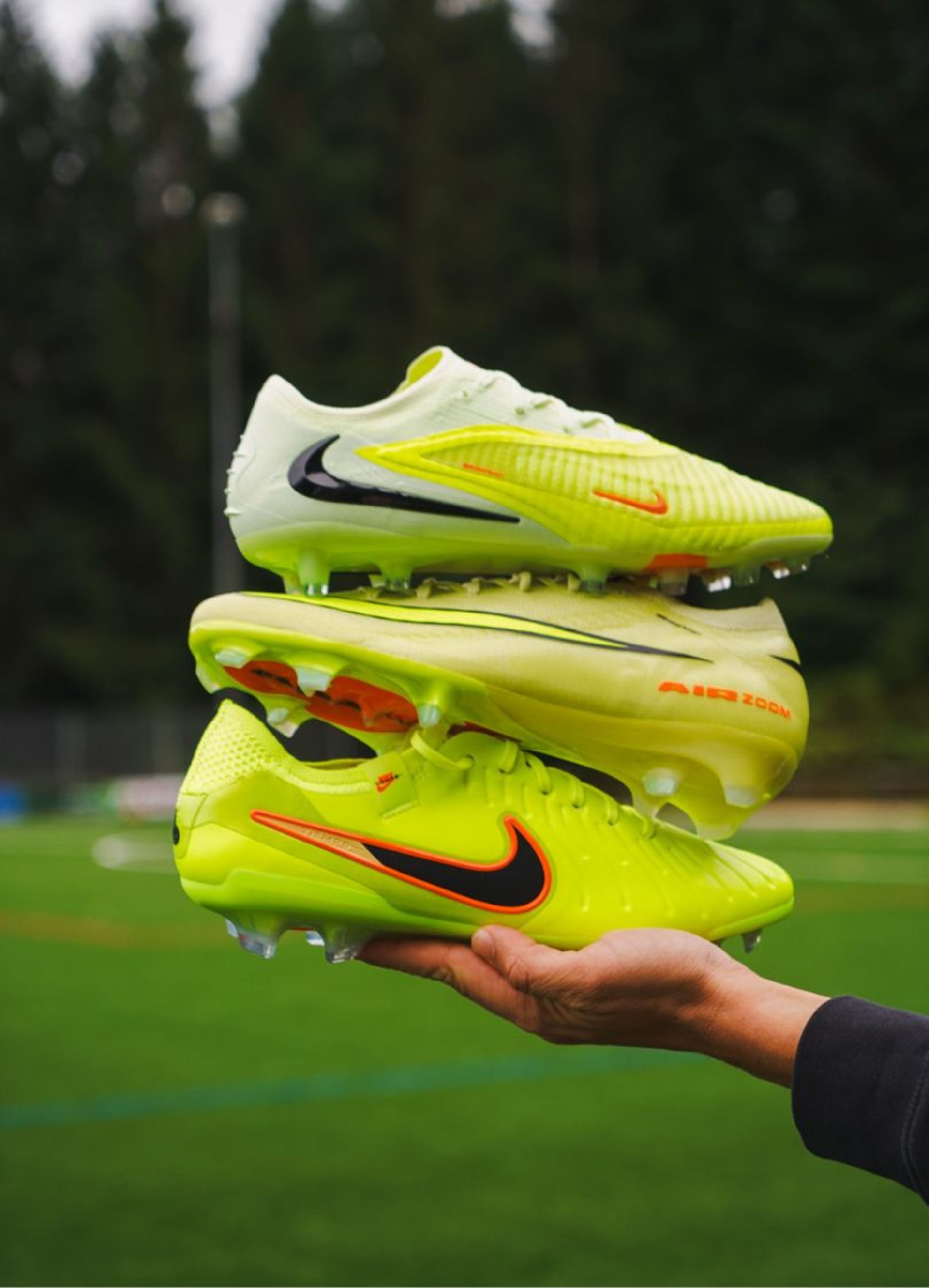 A pair of purple Nike Gear Up football boots on the grass.