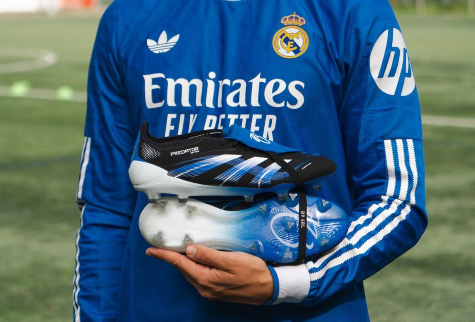 A pair of Radiant Blaze Pack football boots lying on the grass.