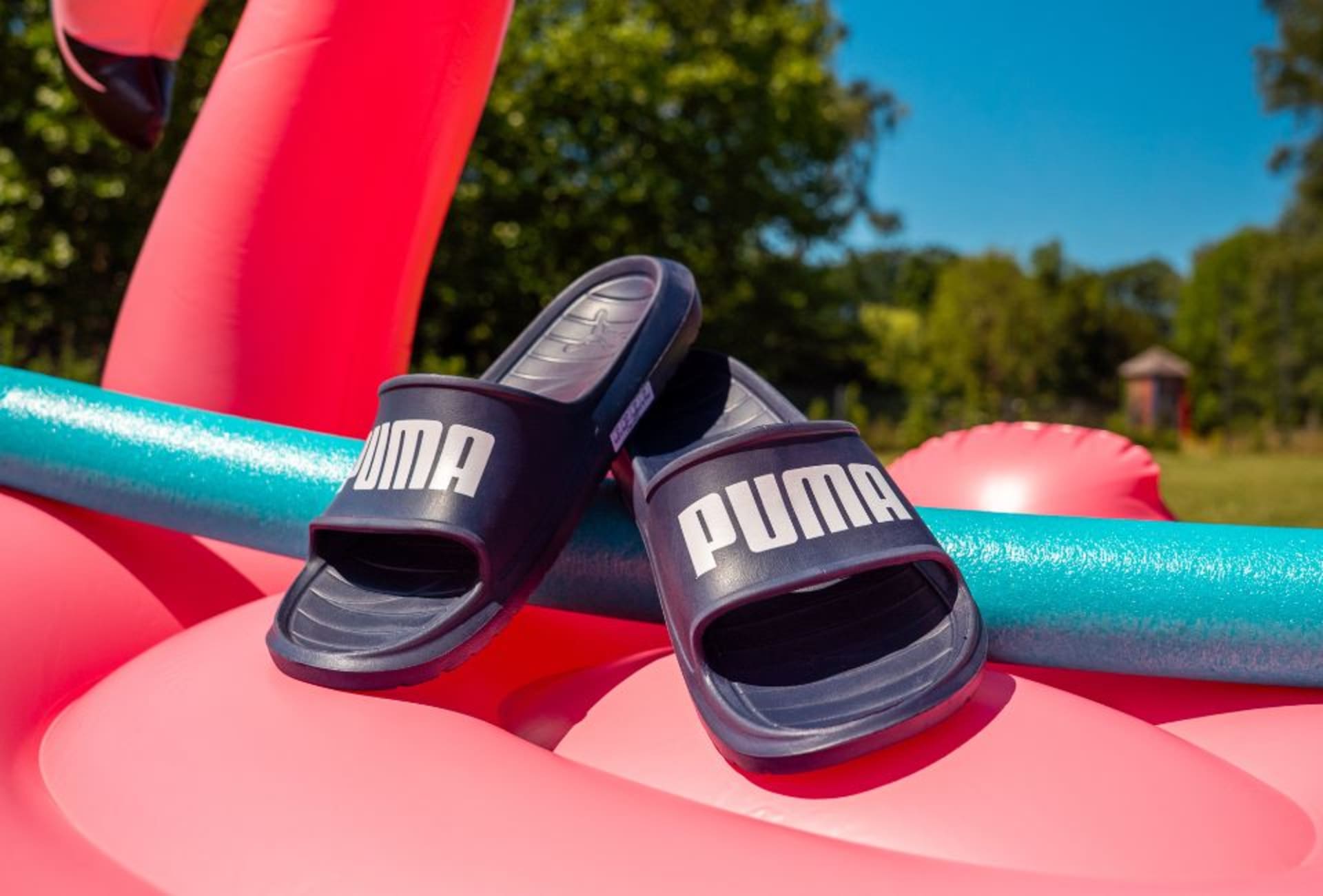 Three adidas Coral Blaze Pack football boots on the grass.