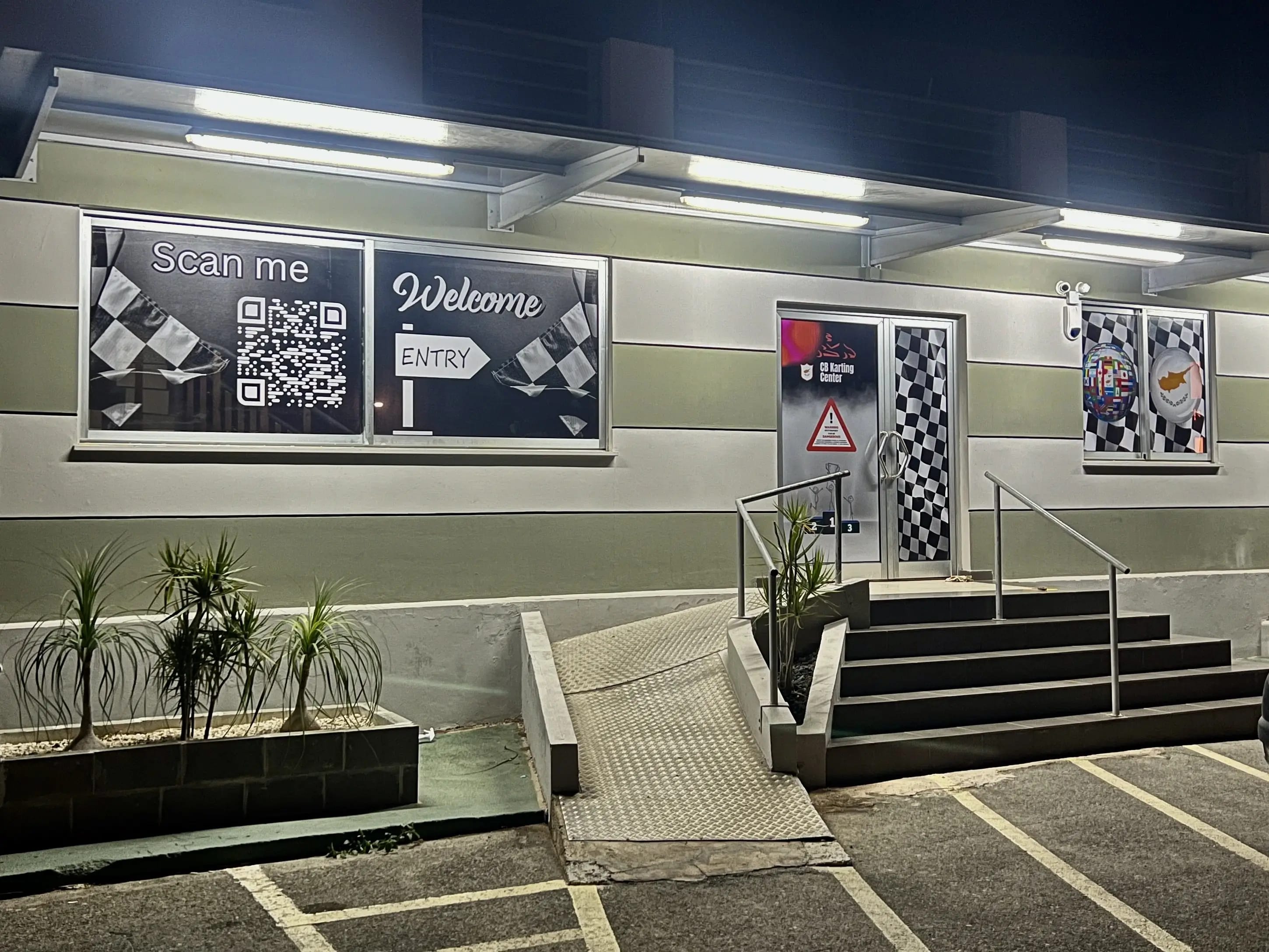 Entrance to CB-Karting Center with gate and logo on wall