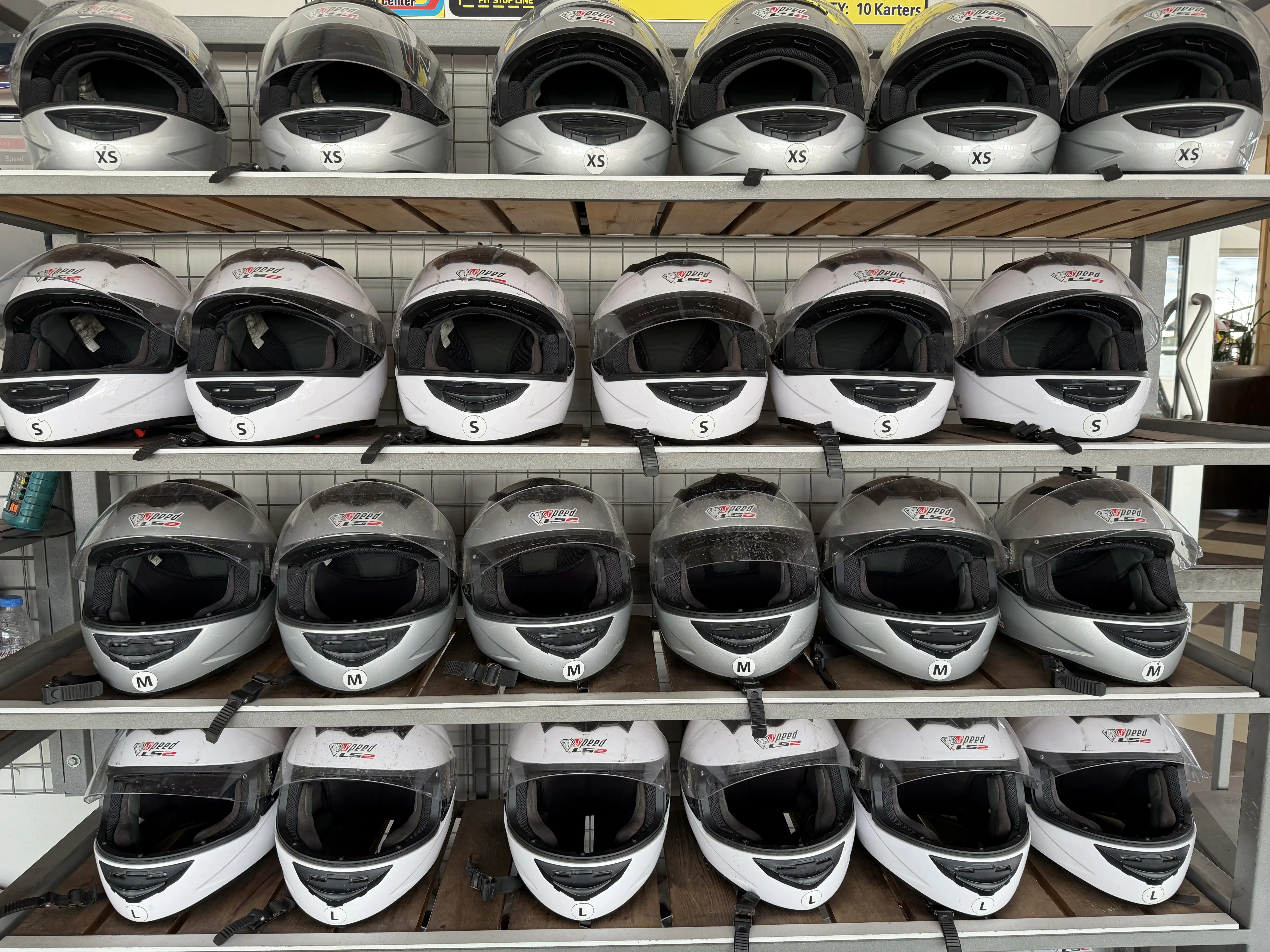 Helmets hanging on wall in pit stop area