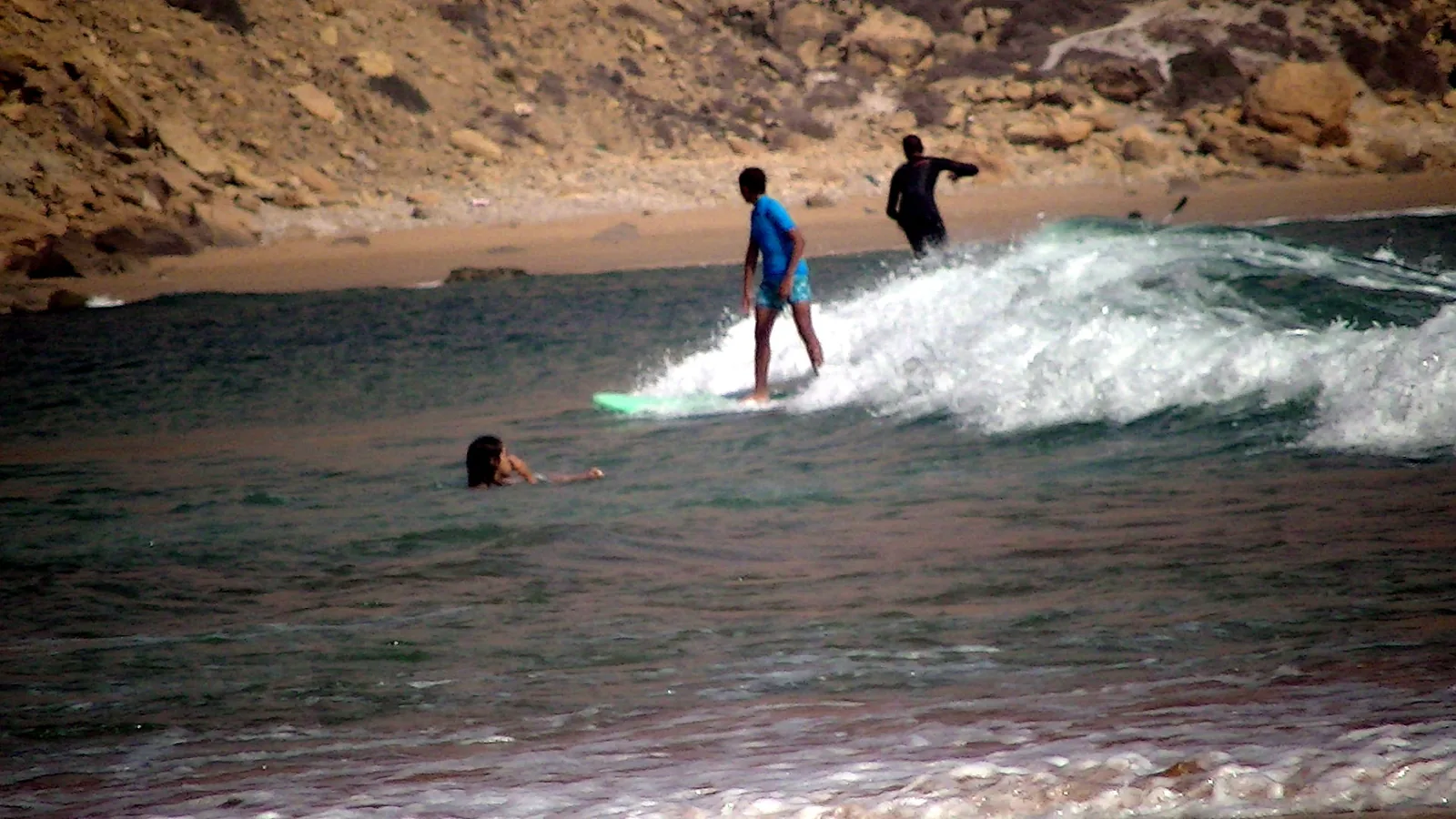 Surfers riding a wave in Imsouane Bay, Morocco
