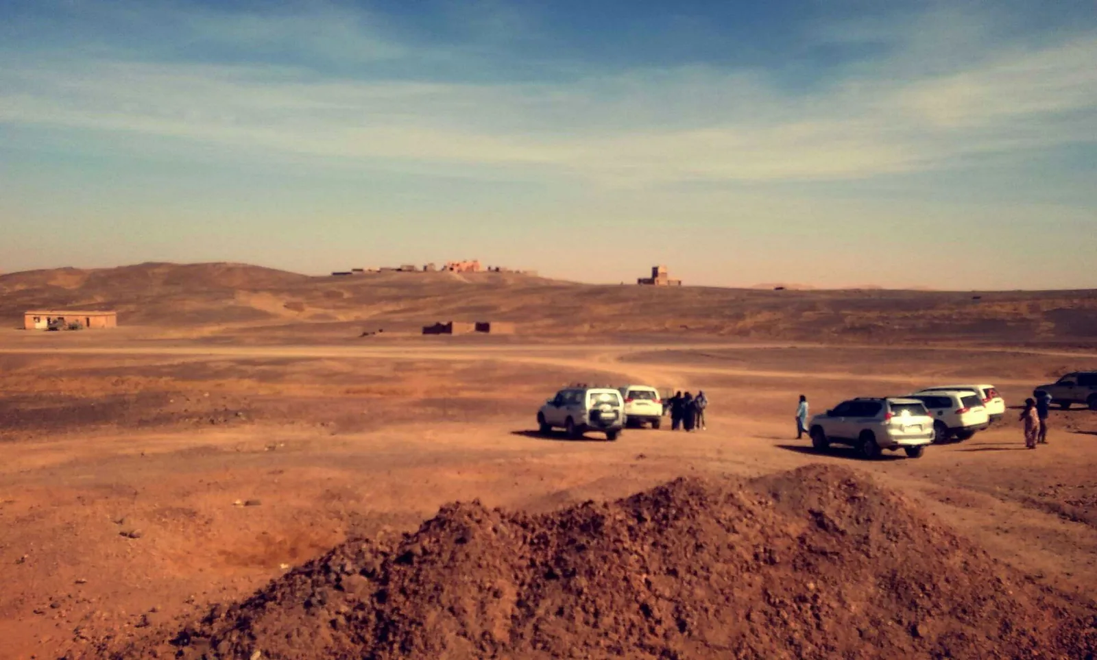4x4 vehicles parked in the Merzouga desert in early morning light