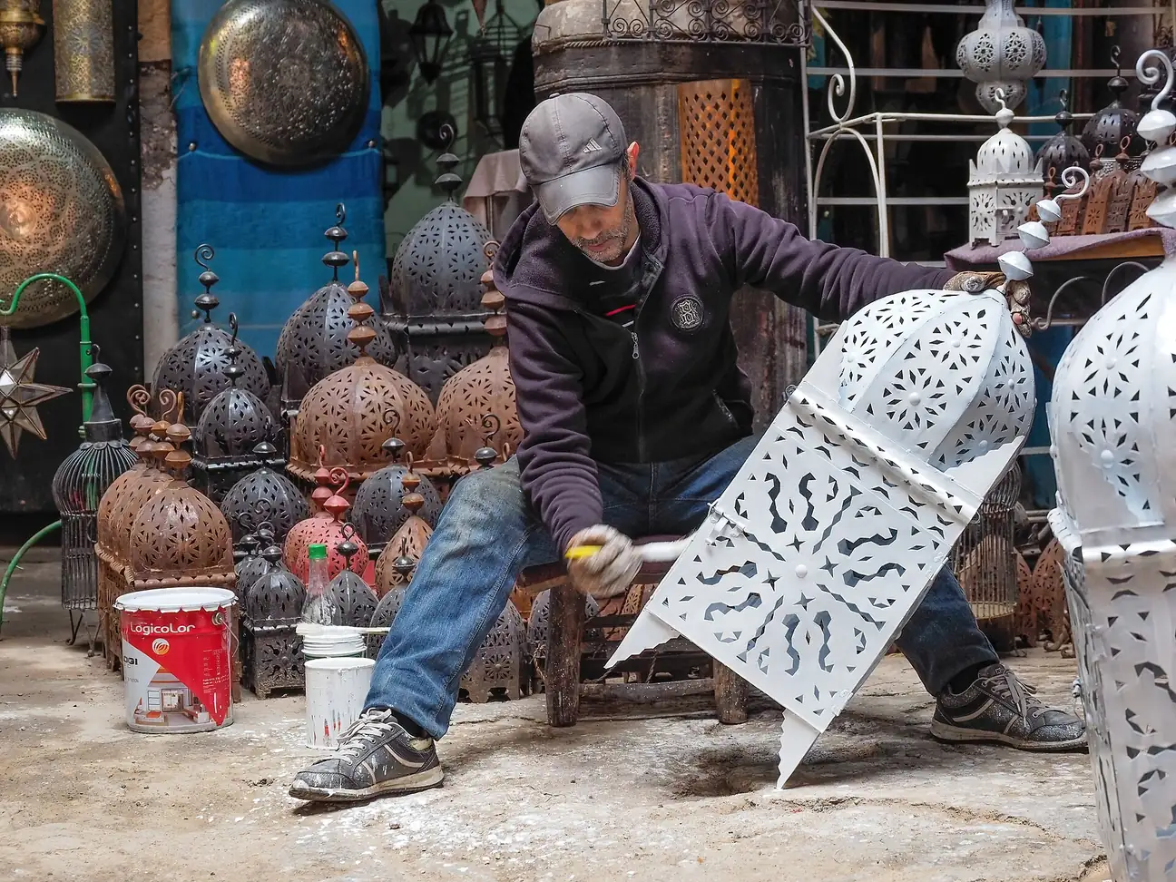 A craftsman making metal lanterns in a workshop in the Marrakech Medina