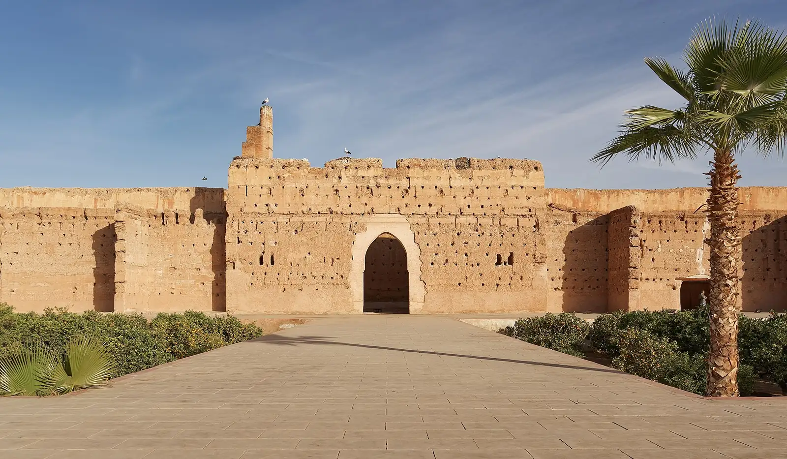 A long pool reflecting the walls of El Badi Palace