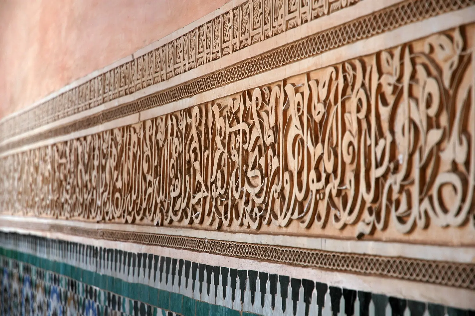 Carved calligraphy and stucco on the walls of the Ben Youssef Madrasa