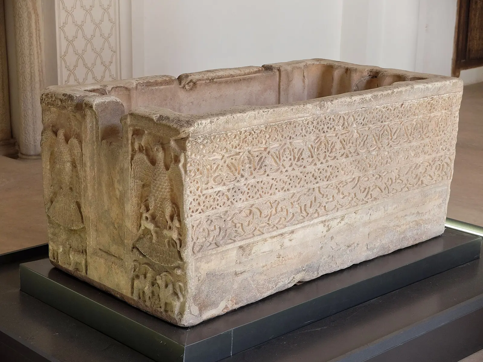 A carved Andalusian marble basin displayed at the Ben Youssef Madrasa