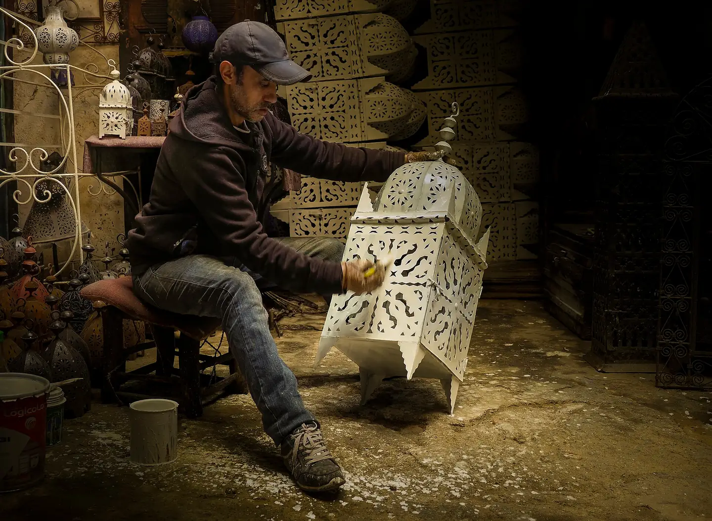 Artisan colouring a lamp in the Marrakech Medina