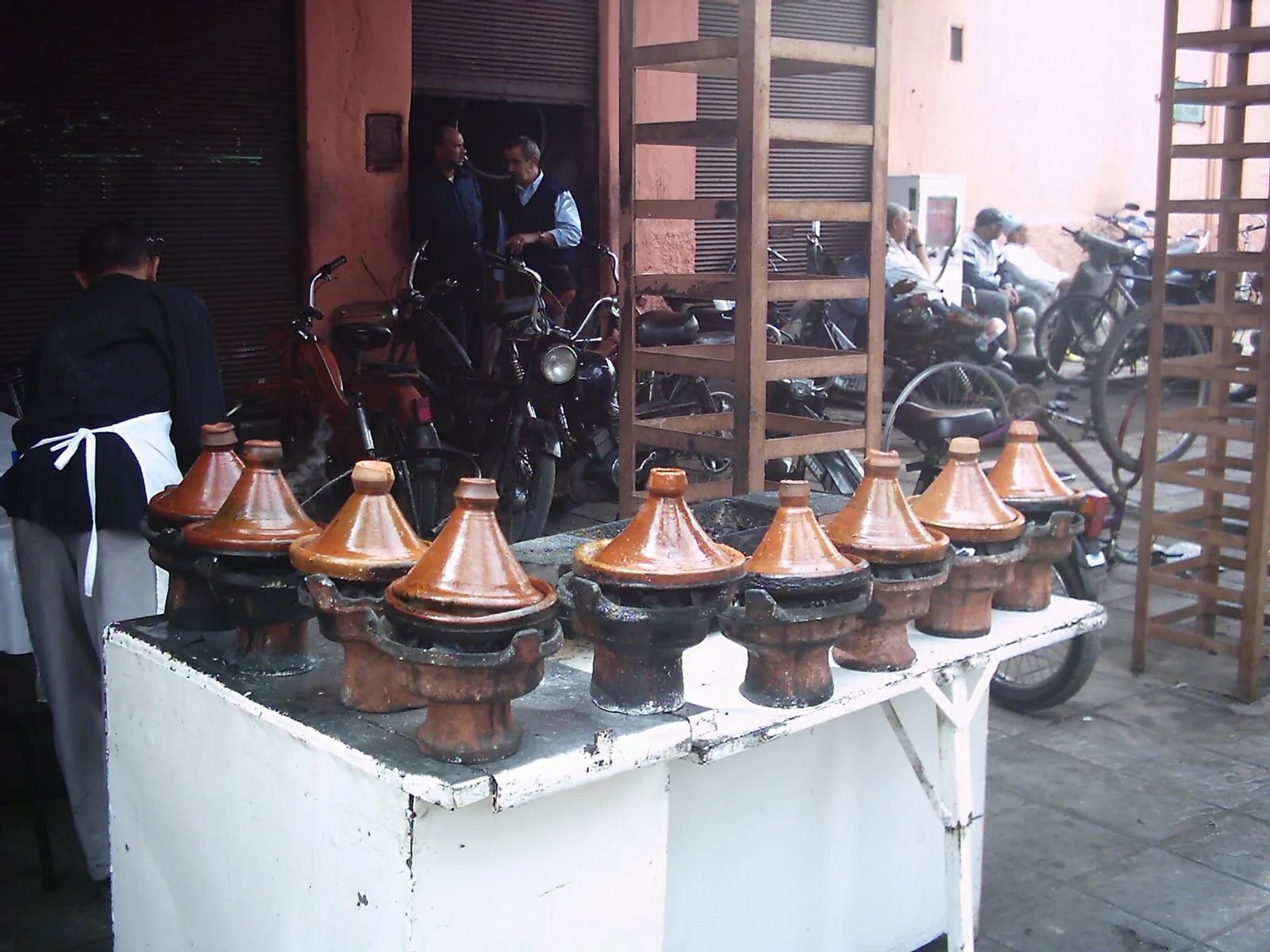 Clay tagines cooking at a stall in Marrakech
