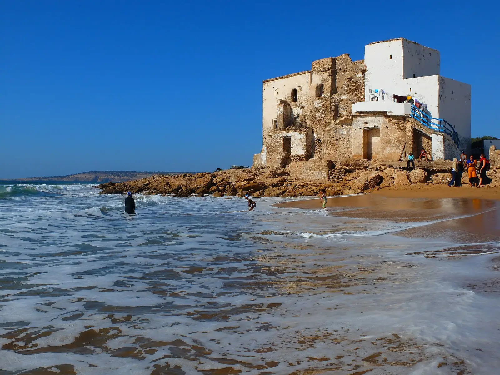 Sidi Kaouki beach with the white marabout on the shore