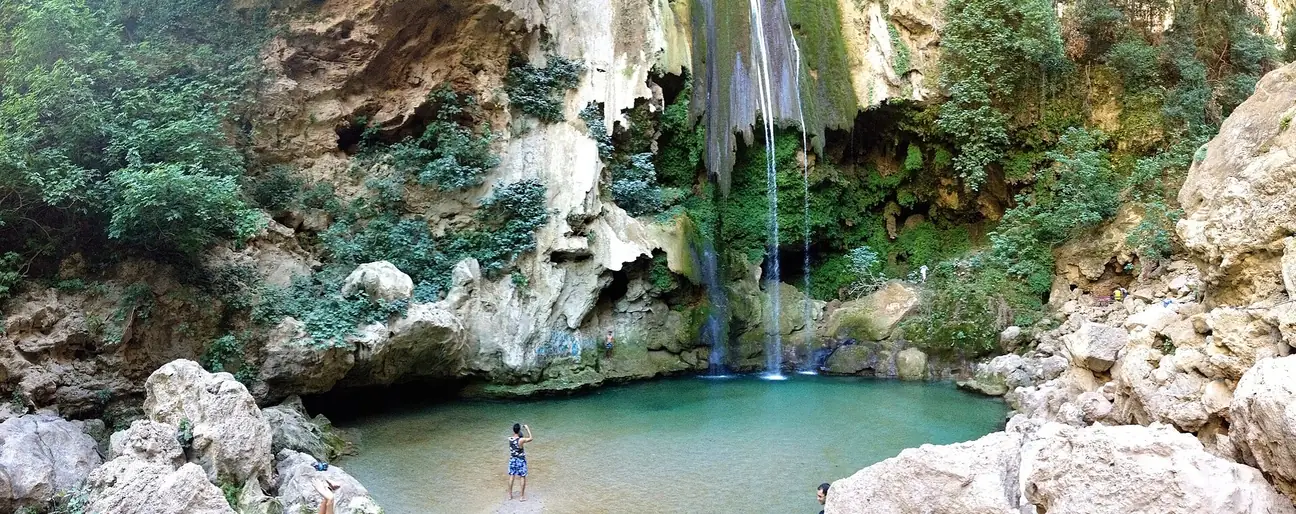 Akchour waterfall pouring into a turquoise pool