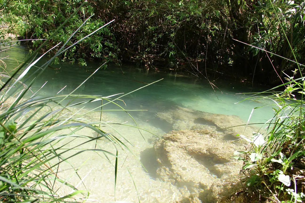 Clear river water flowing over rocks at Akchour