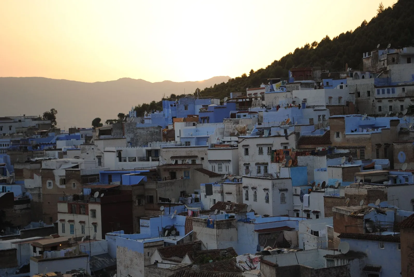 Chefchaouen’s blue houses in warm sunset light