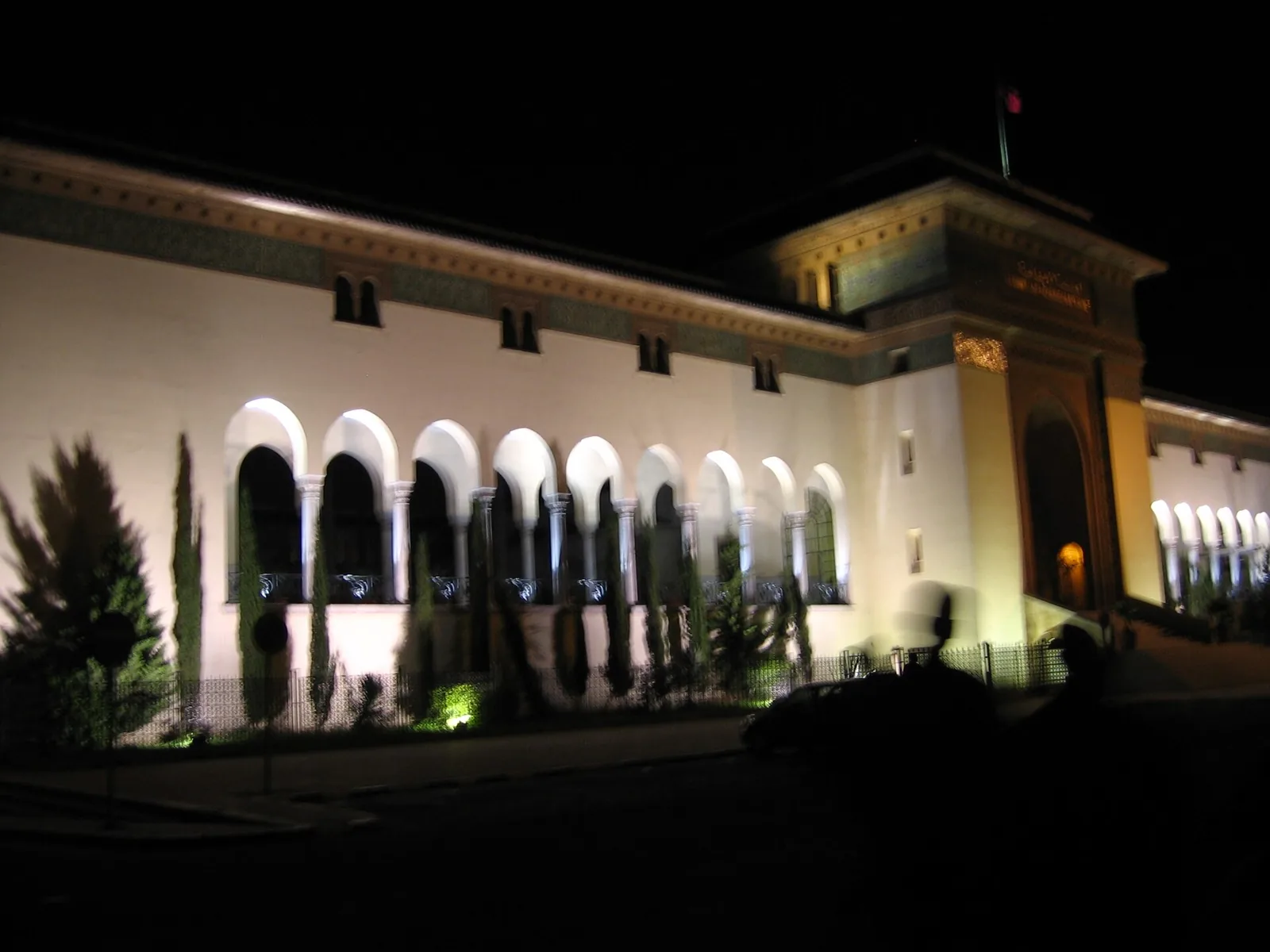 Arcaded civic building on Mohammed V Square lit at night