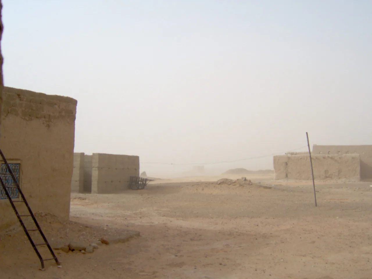 Village houses during a sandstorm, Khamlia Village