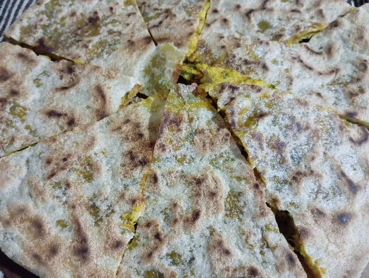 A whole golden Berber pizza fresh from the fire