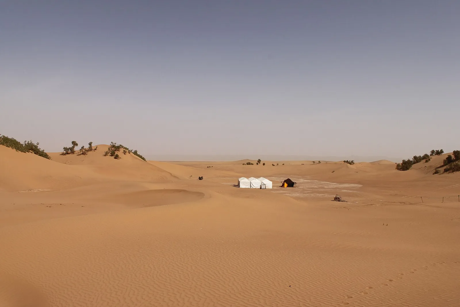 Sand dunes and a lone building in the desert near Zagora