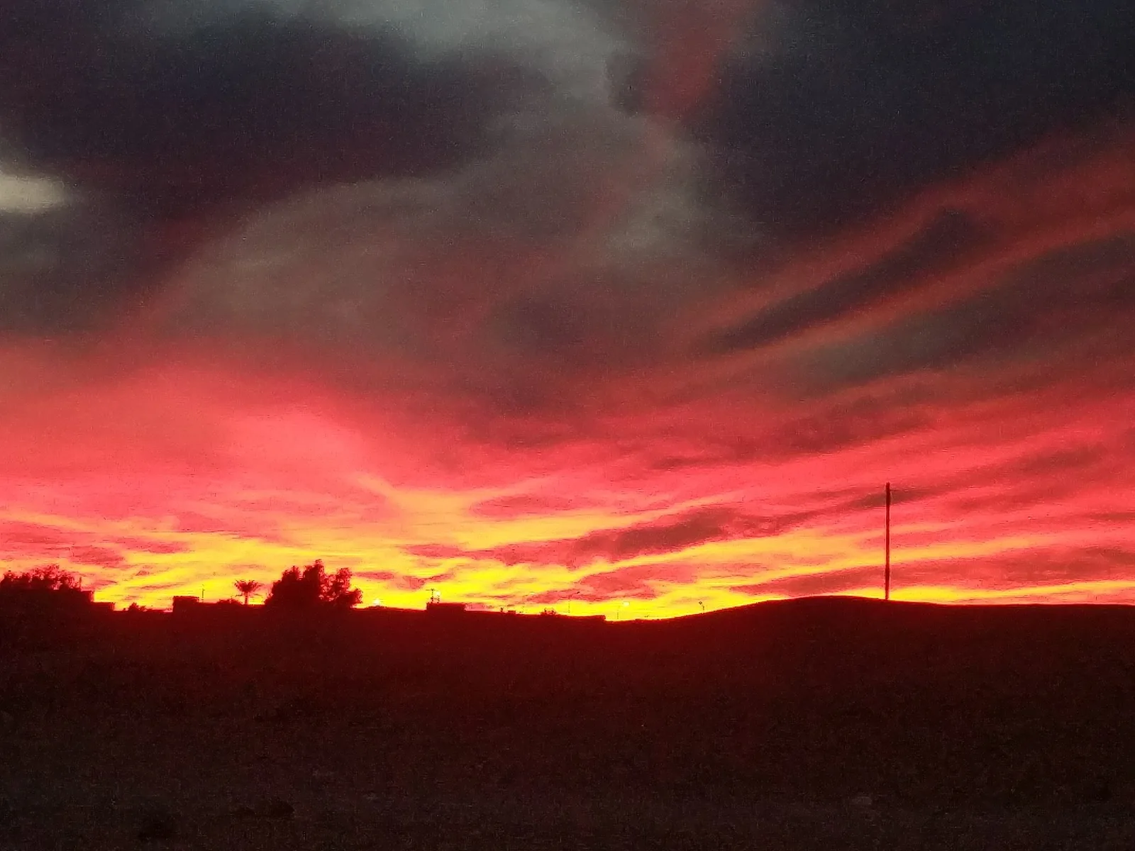 A fiery red sunset over the desert at M’Hamid El Ghizlane