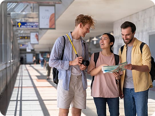 Group of friends looking at a map at the airport