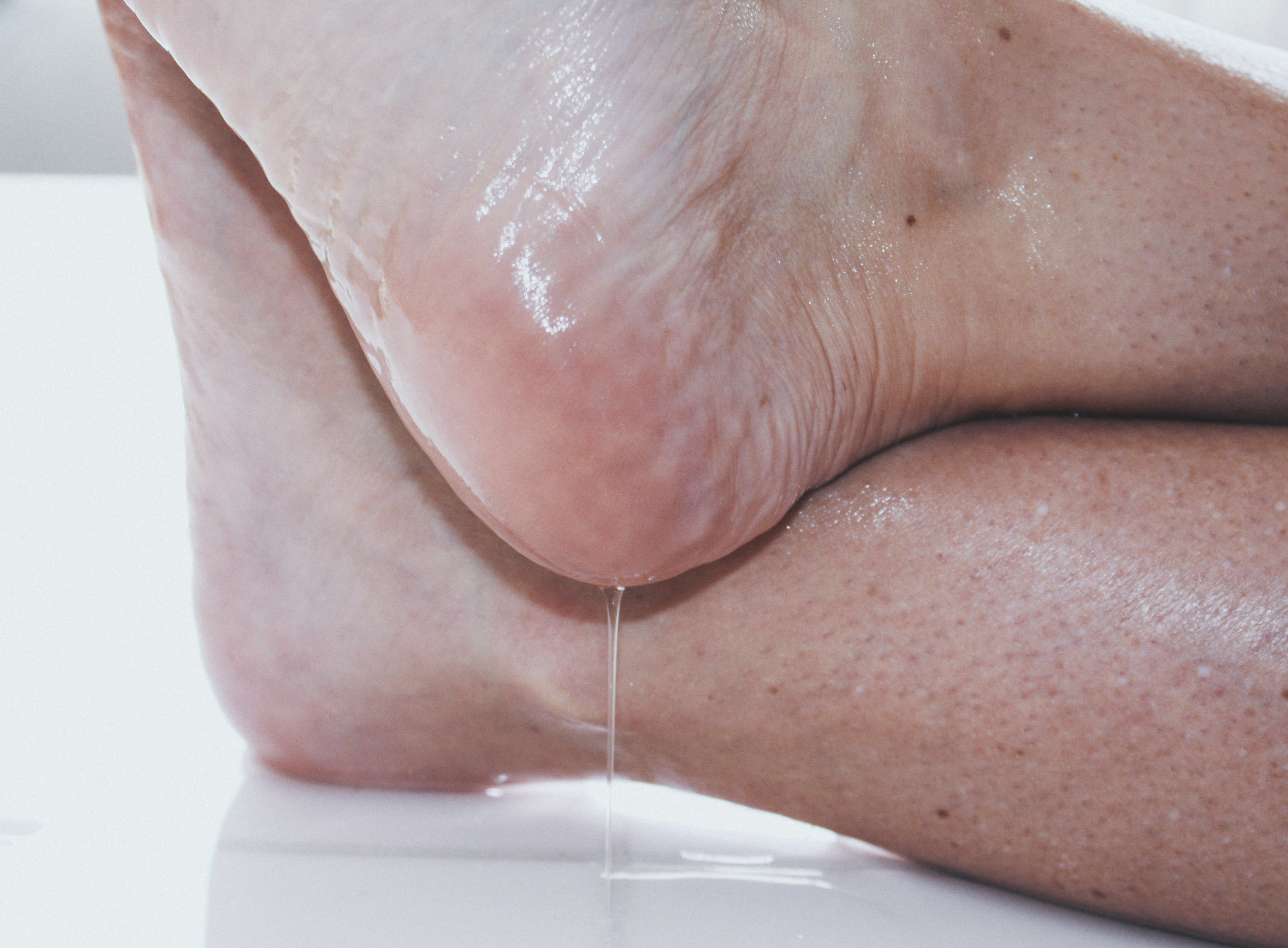 baby oil dripping from a woman's heel