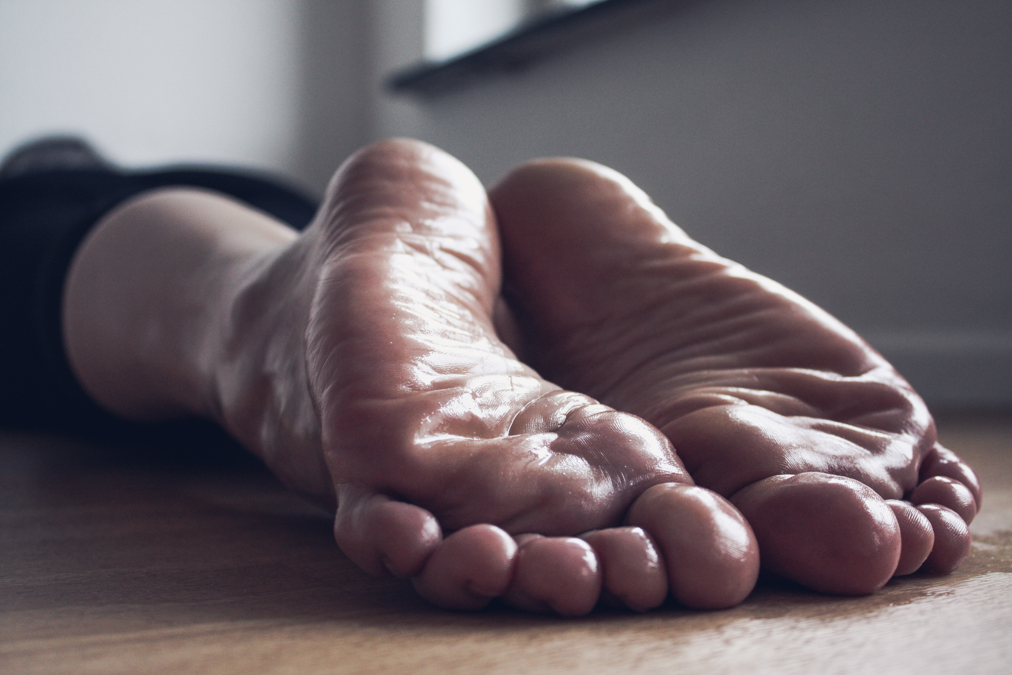 a woman's laying on the floor with her feet covered in baby oil