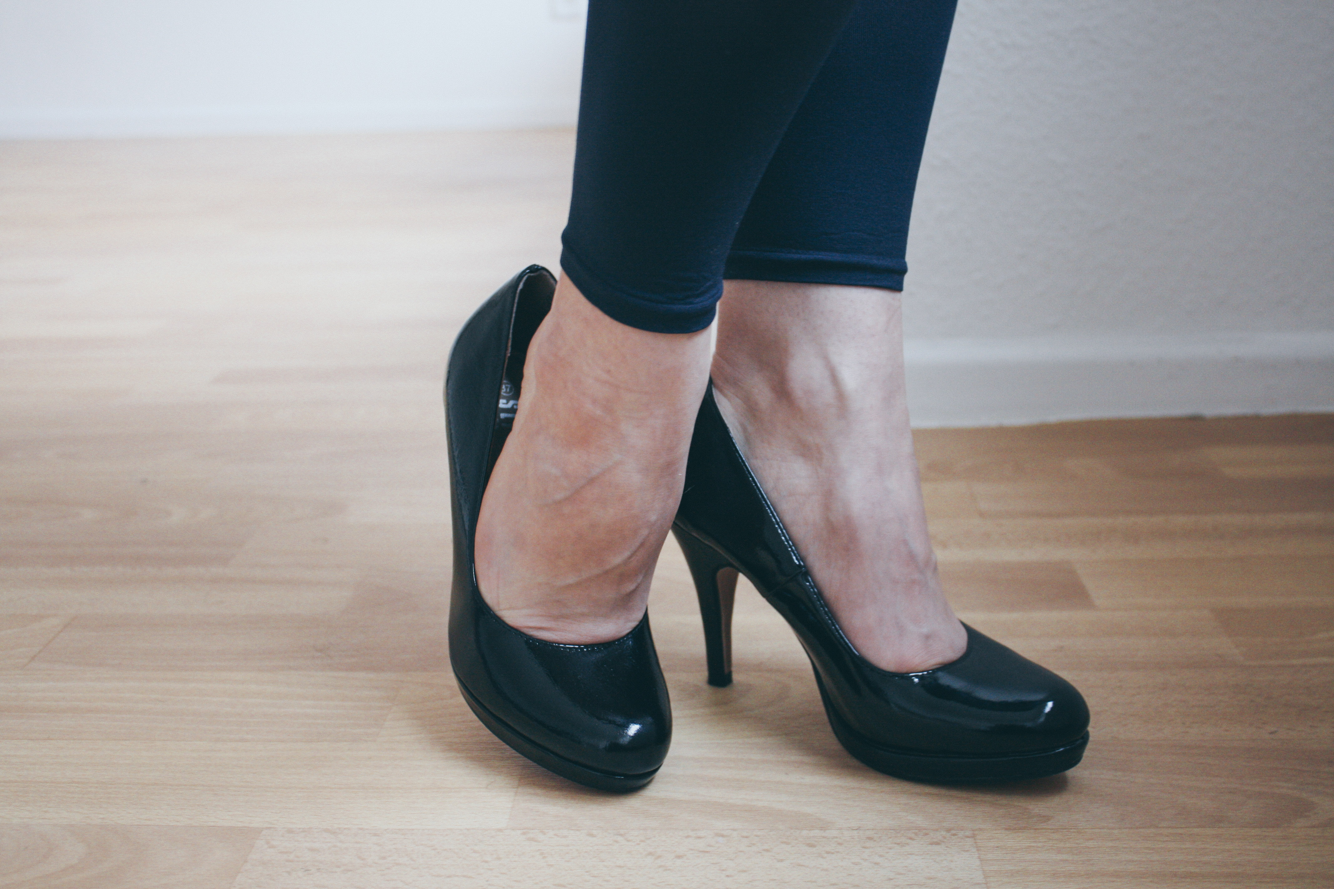 a woman's feet in black high heels