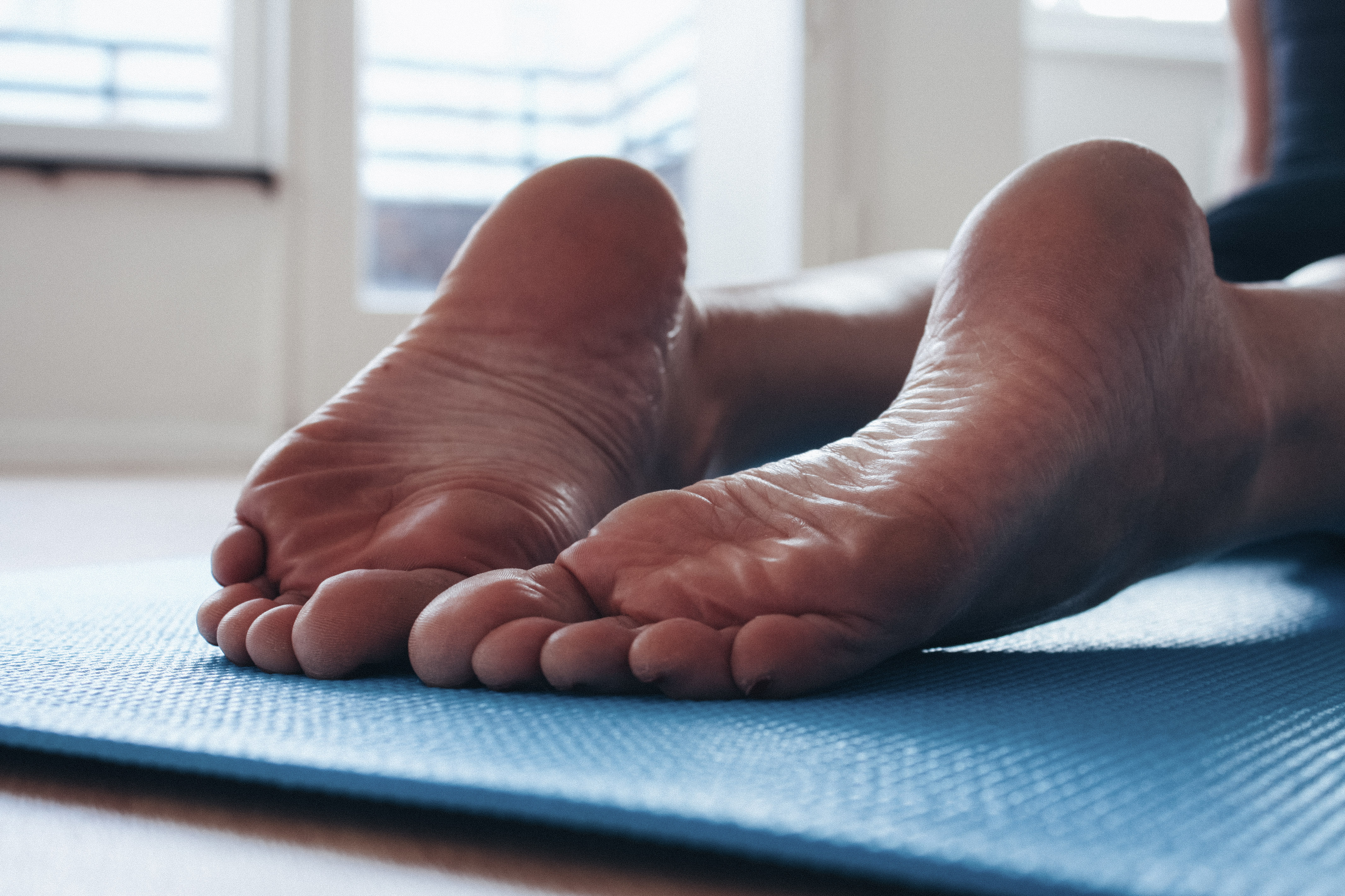a woman's soles as she's lays on a yoga mat