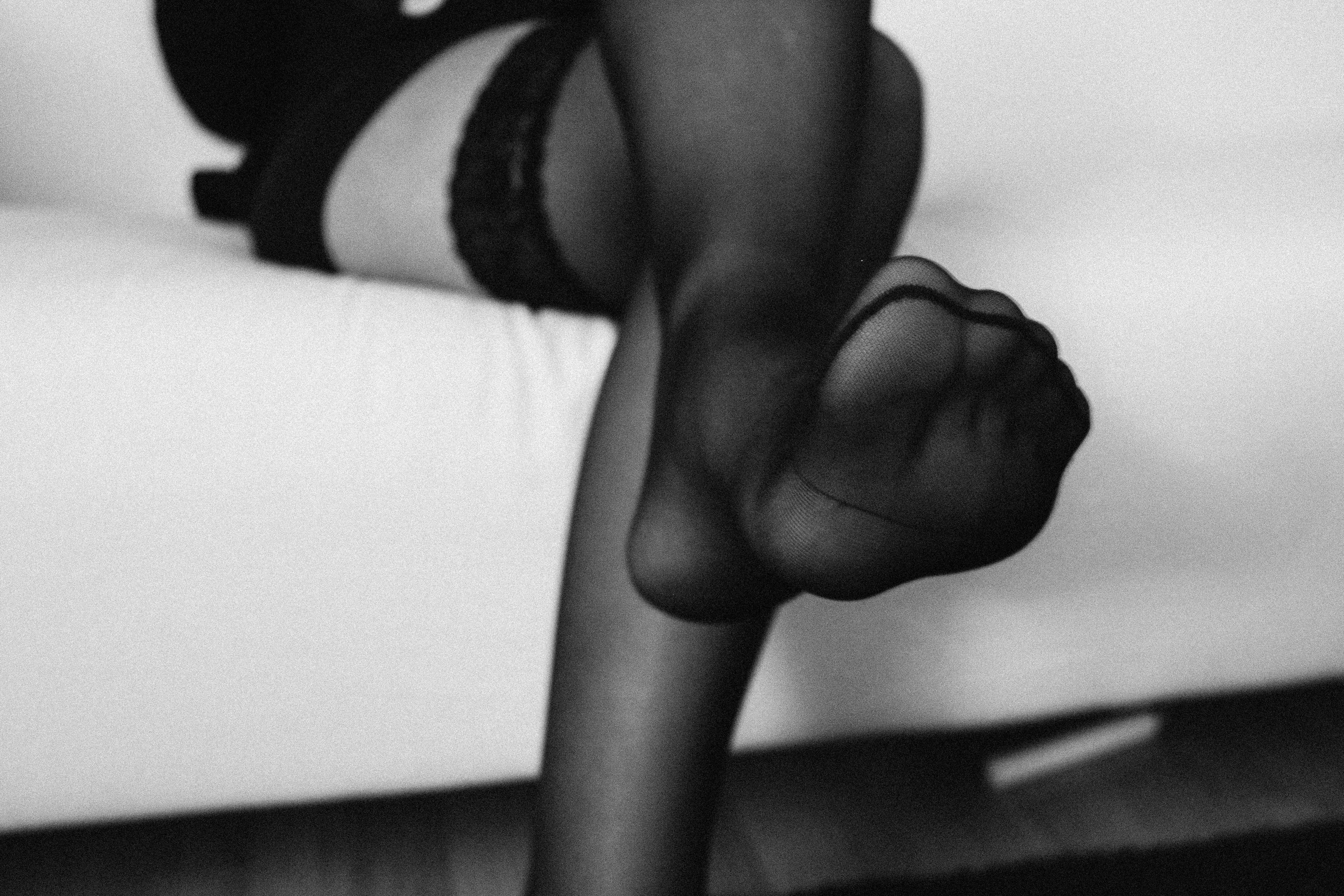 a woman in black nylons pointed her toes towards the camera