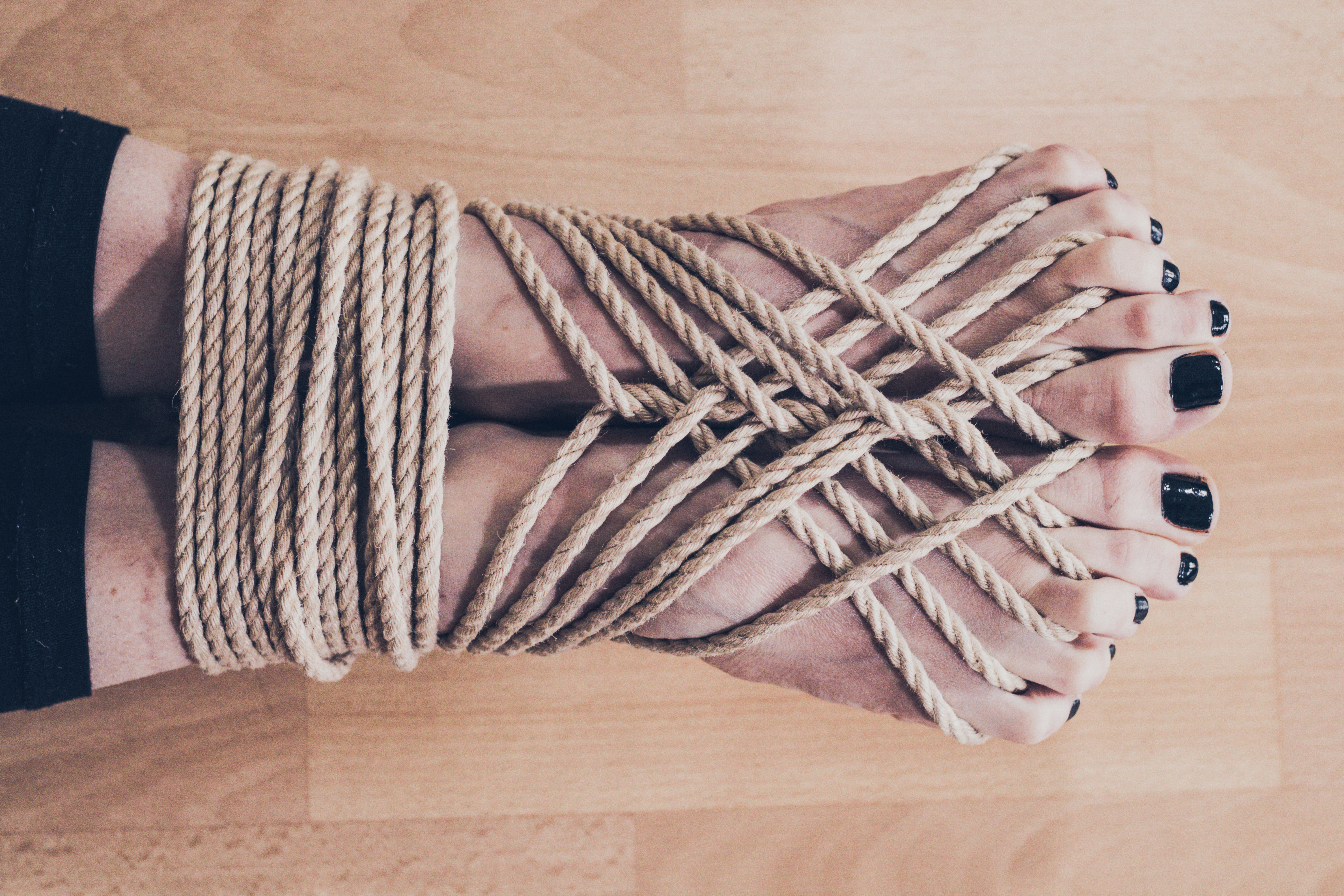a woman's feet bound in shibari style bondage