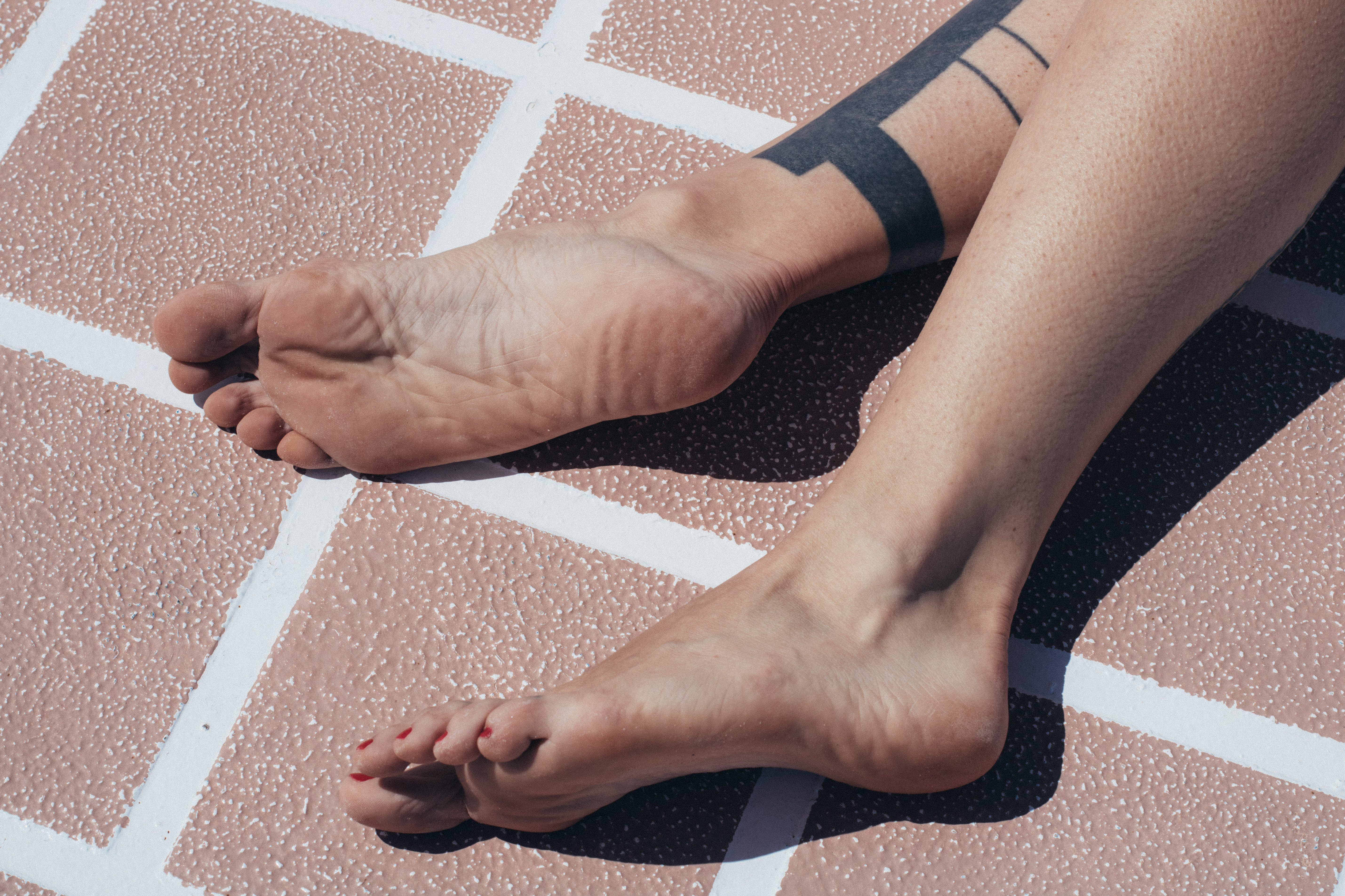 close up shot of woman's soles on the deck of boat