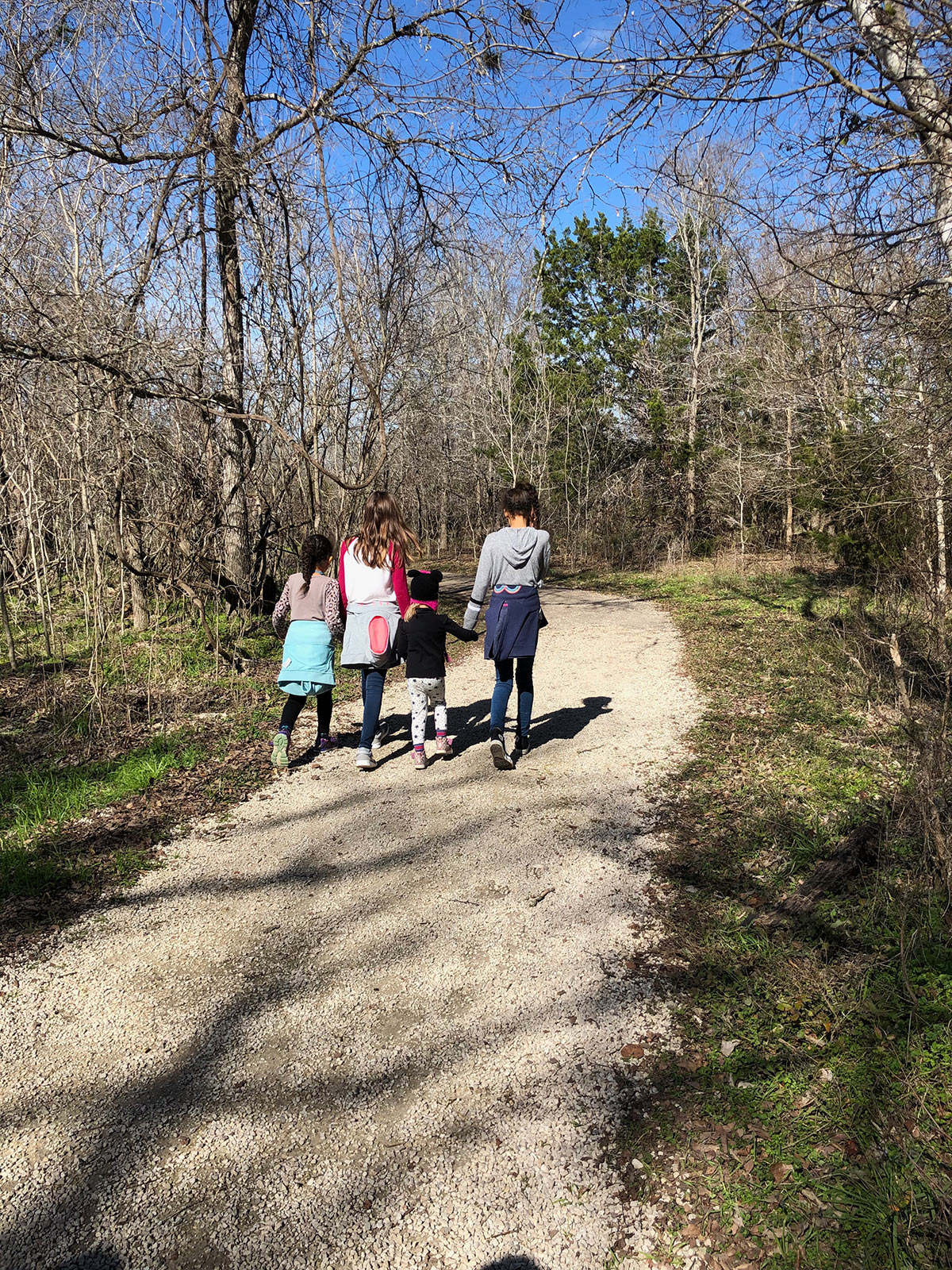 four children hiking on a trail