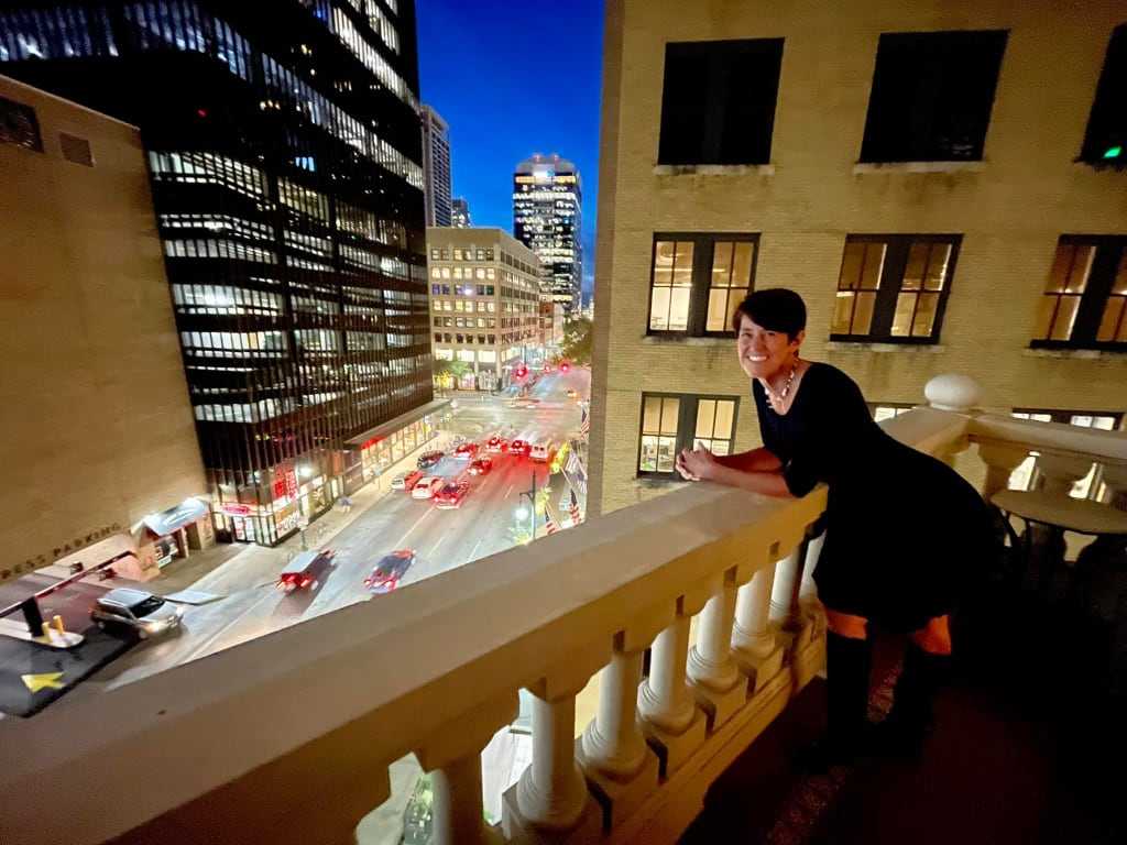 Pam LeBlanc looks over Sixth Street from the Driskill balcony