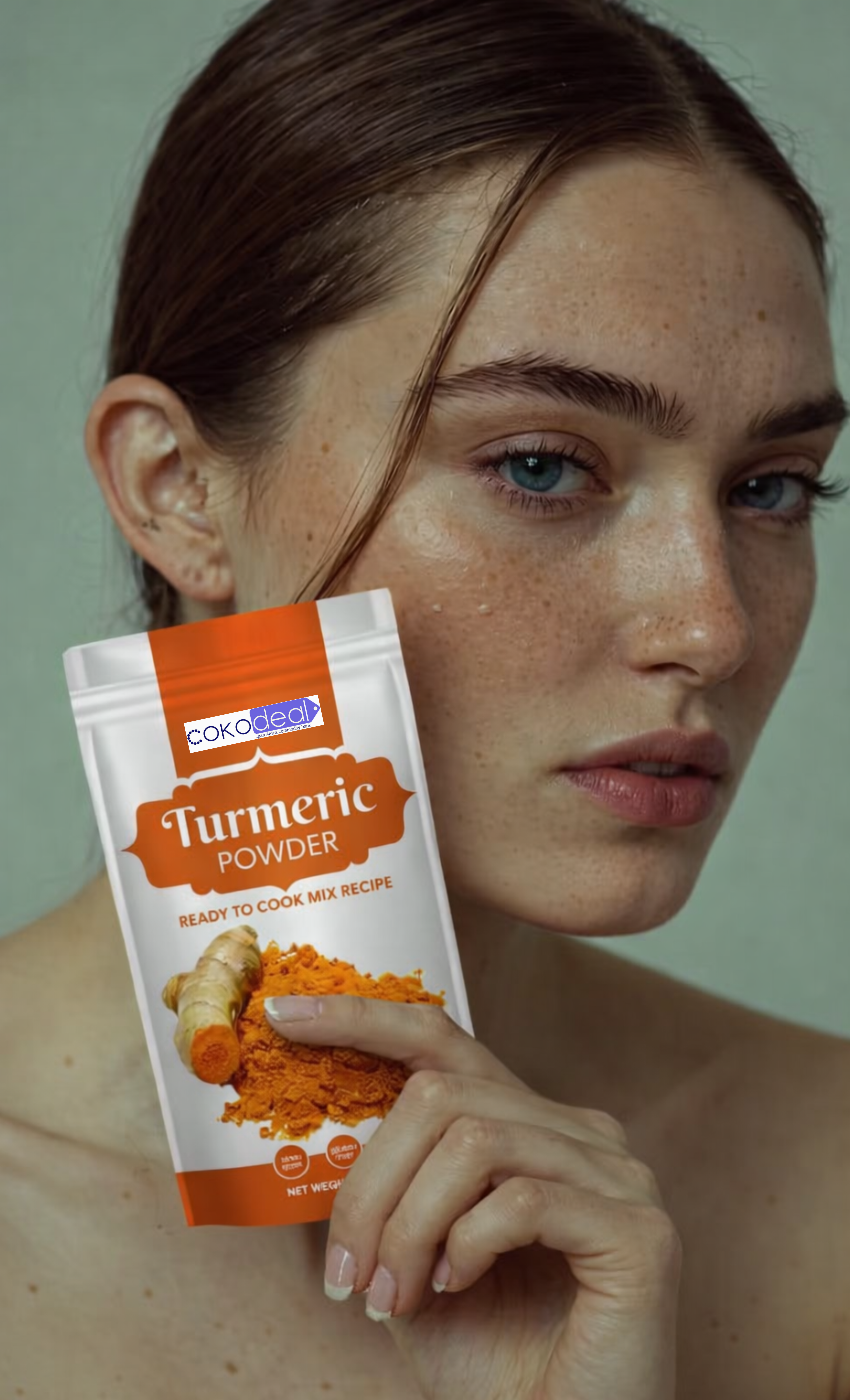 Close-up of a freckled woman with blue eyes holding a small dropper bottle near her chin.