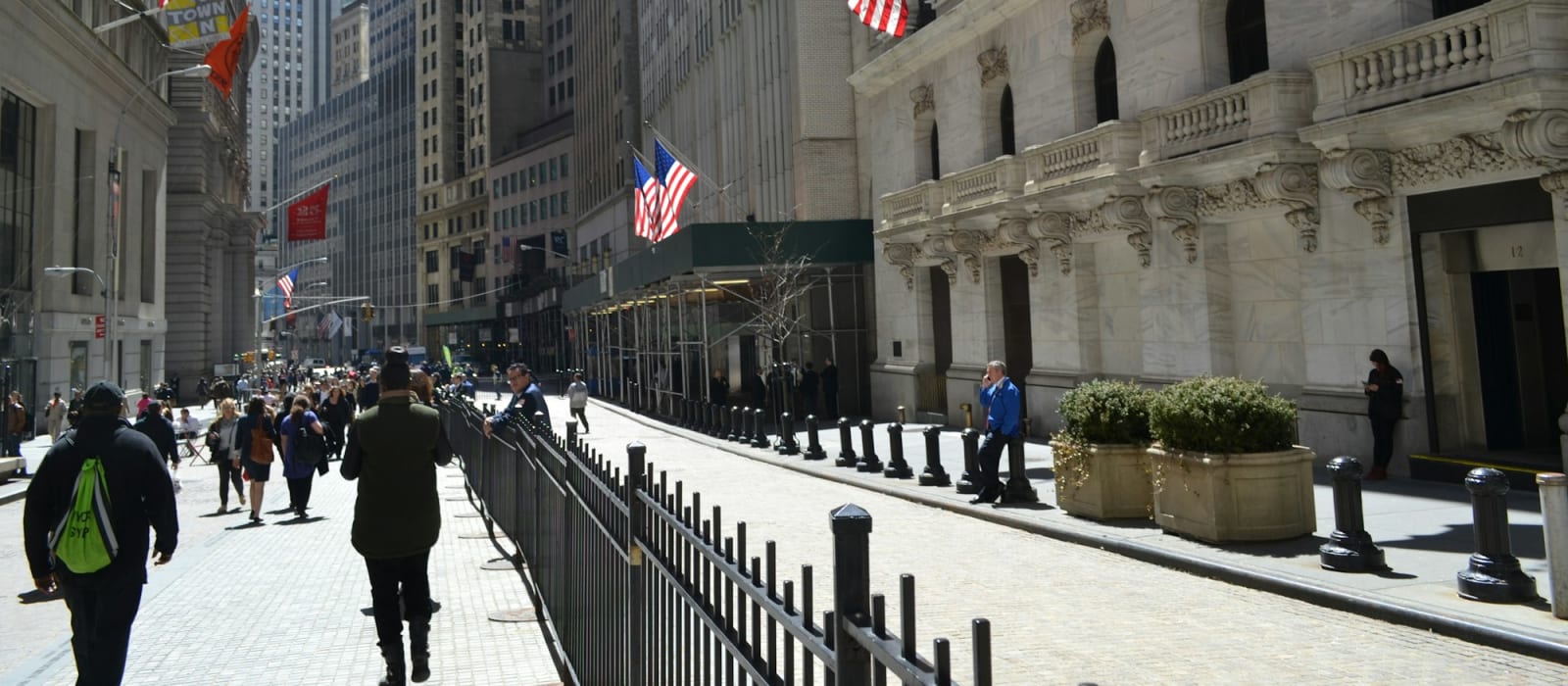 Wall Street in New York with American flags on the buildings